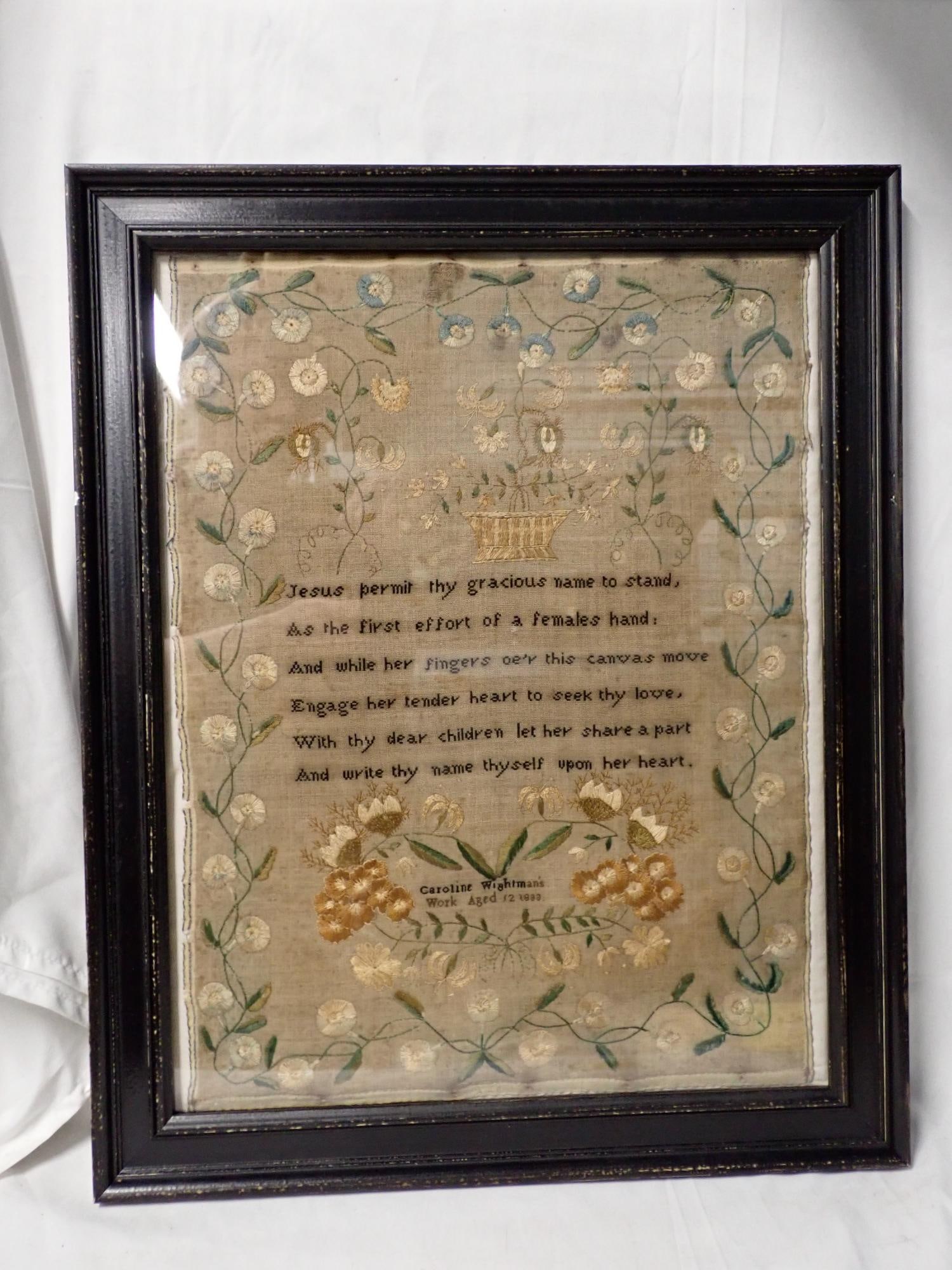 1833 Carole Wightman's Sampler: Carole Wightman's Work Aged 12 1833. Religious verse in center. Motif Flowers, baskets. Crewel work. Vine and floral border. Slight fabric discoloration Frame 21 x 17 Sampler 17 1/2 x 13 1/4