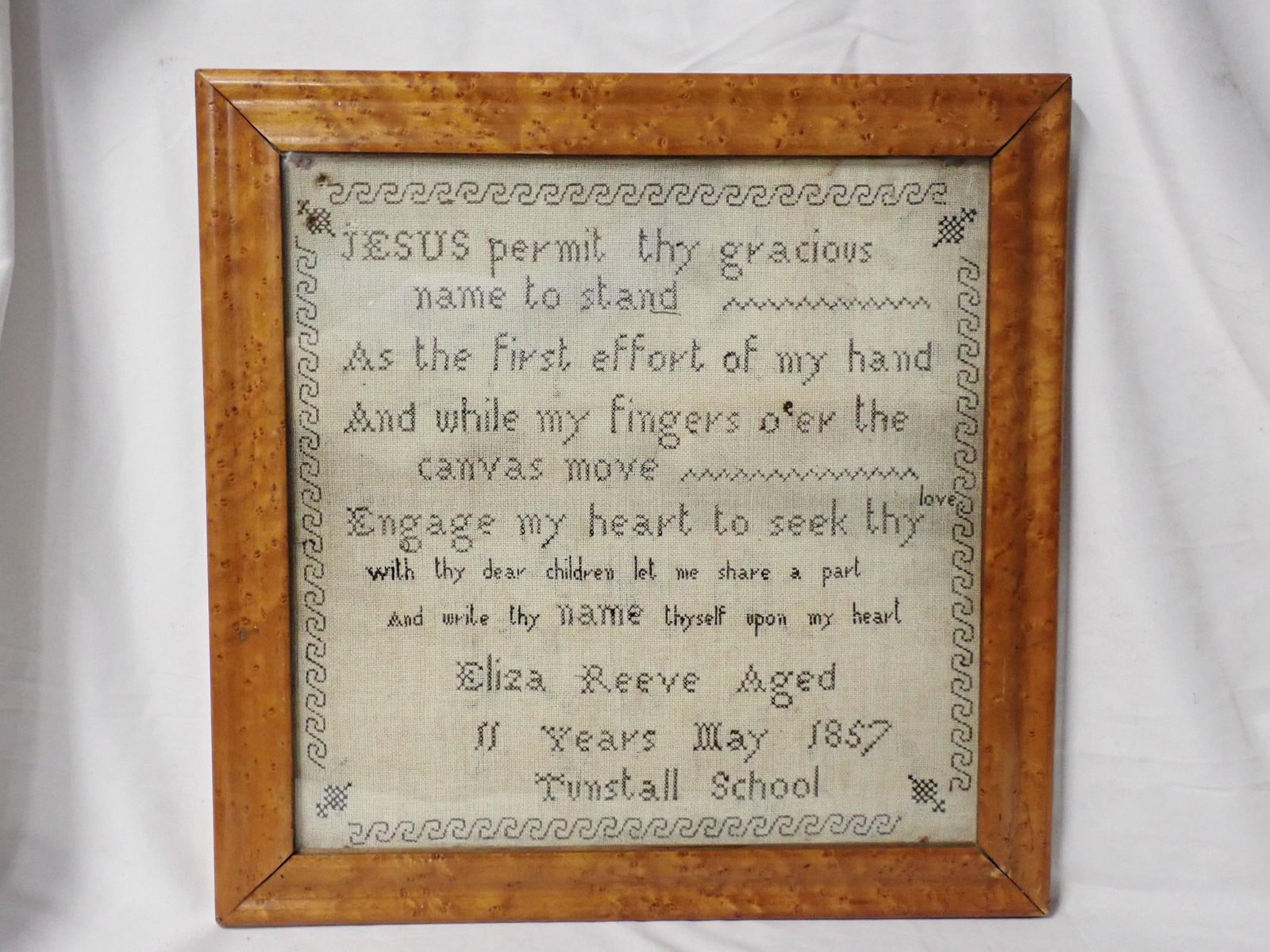 1857 Eliza Reeve Sampler: Eliza Reeve Aged 11 Years May 1857 Turnstall School. Verse in center. Geometrical border. Frame 15 1/4 x 15 1/4 Sampler 12 1/4 x 12 1/4