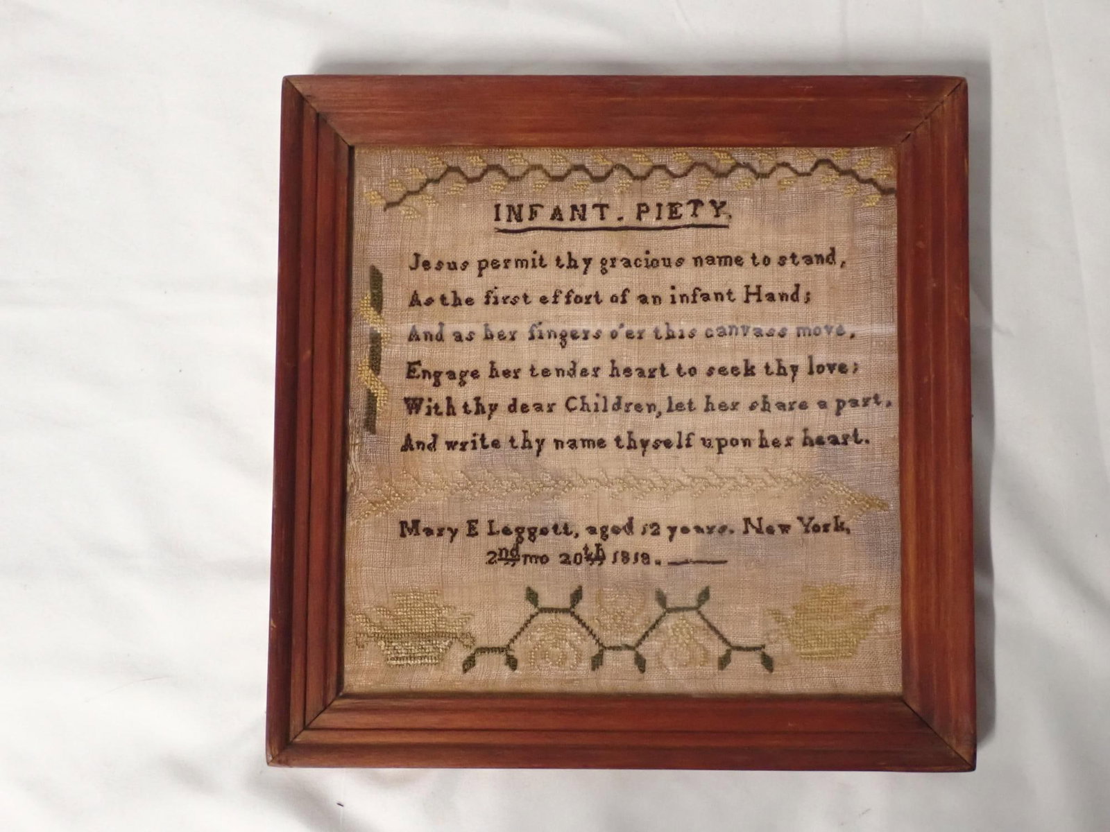 1818 Mary E. Leggett Sampler: Mary E Leggett aged 12 years, New York 24th mo 20th 1818. Religious verse titled Infant Piety Motif vines, flowers, baskets. Frame 9 1/2 x 9 1/2 Sampler 7 3/4 x 7 3/4