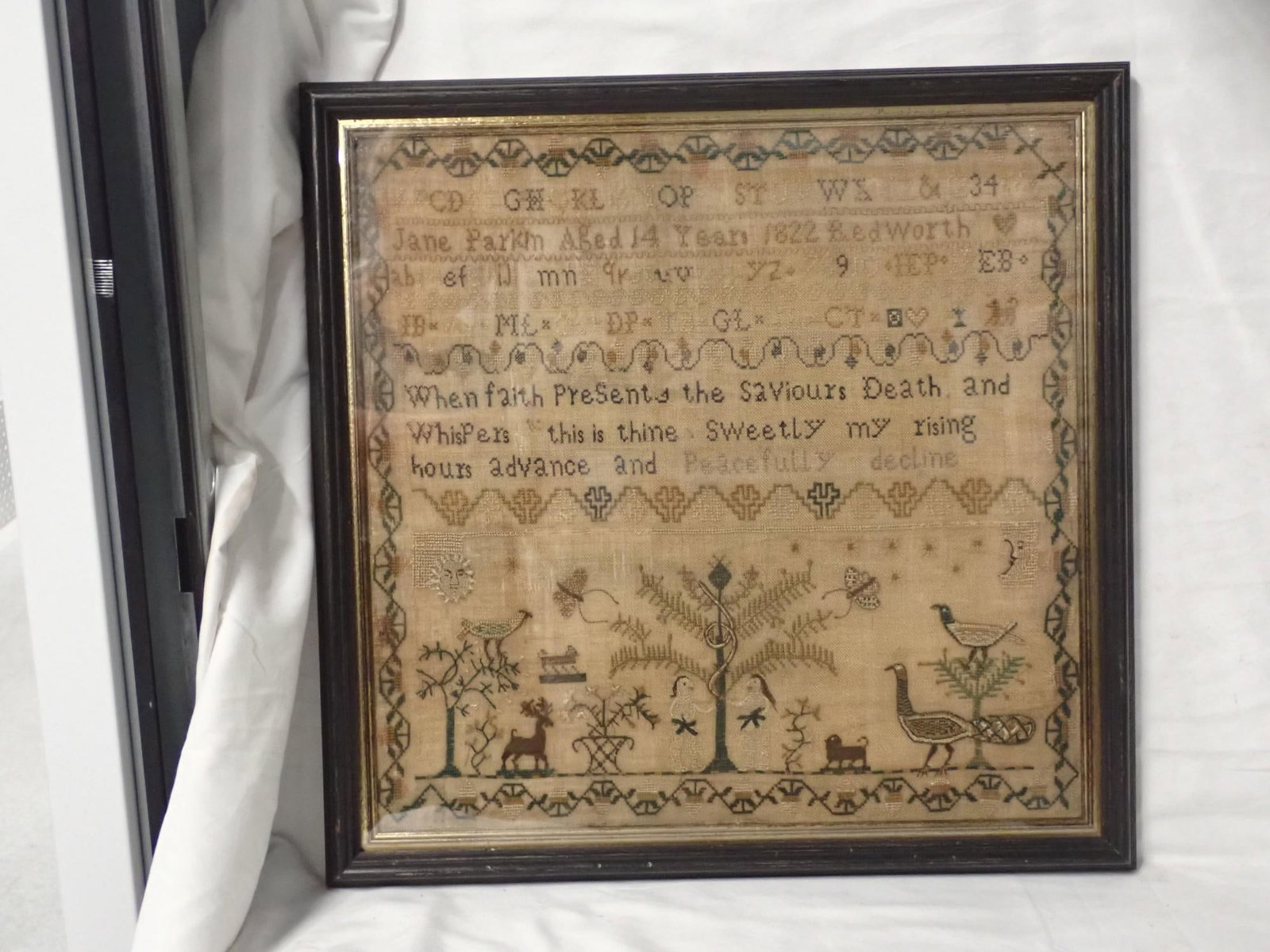 1822 Jane Parkin Sampler: Jane Parkin Aged 14 Years 1822 Red Worth. Alphabet and numbers Religious verse in center. Motif Adam and Eve, Peacocks birds stag and other animals butterflies sun moon and stars. Vine and floral