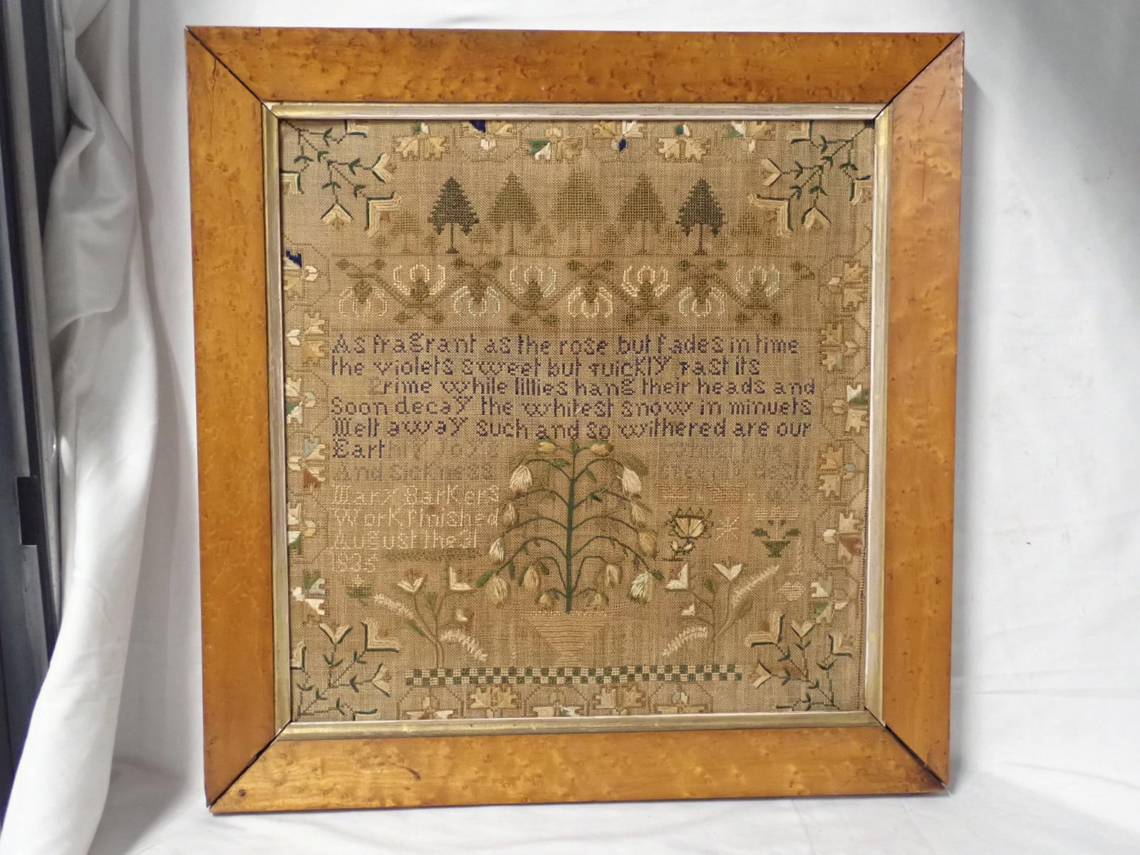 1835 Mary Barker Sampler (no glass): Mary Barkers work finished August the 31, 1835. Verse at top. Motif flowers and trees. Vine and floral border. Fabric discoloration. Frame 19 1/2 x 19 1/4. Sampler 15 1/2 x 15