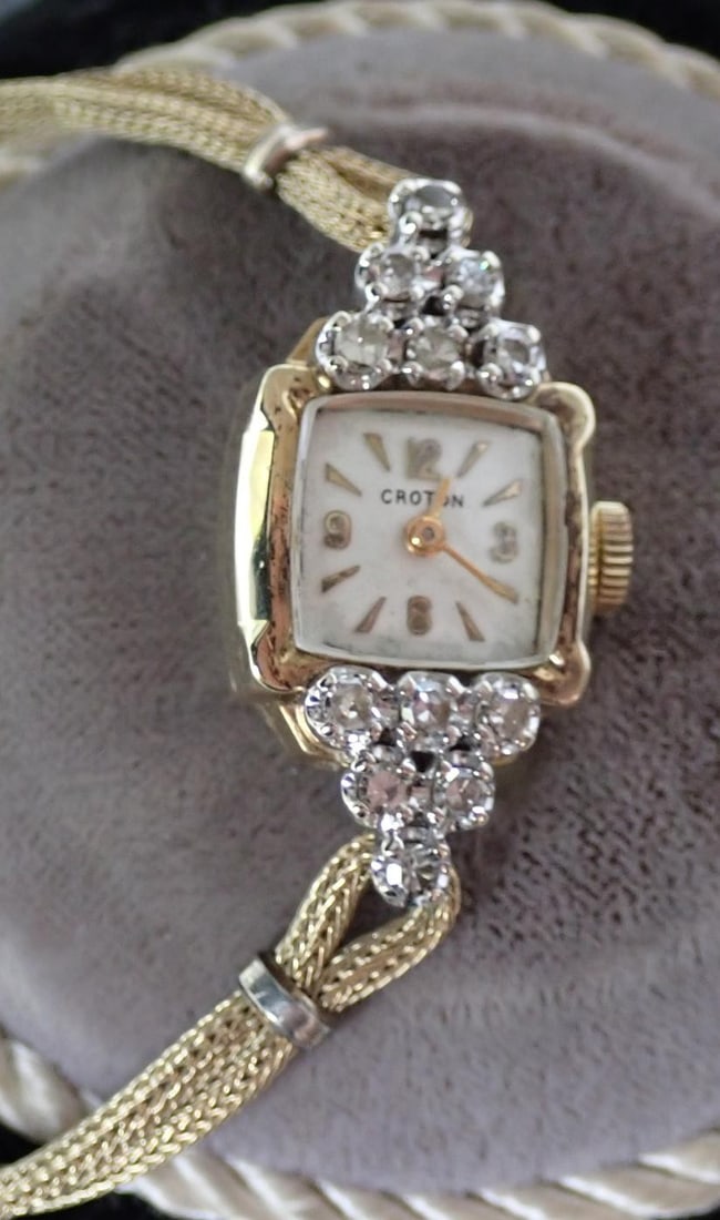 Croton 14K Gold and Diamond Ladies' Wristwatch.: Watch is gold with diamonds. Band is gold filled. Comes in Croton blue crushed velvet box.