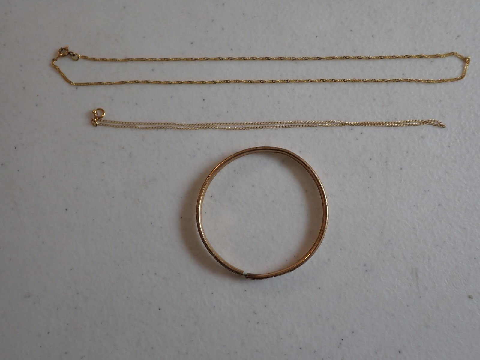 Gold Filled Chains and Baby Bracelet: 1/20 14K 13" Chain, 1/20 12K 15 1/2" Chain, Gold Filled Baby Bracelet. Measures 2 1/8" across. 8.5 Grams