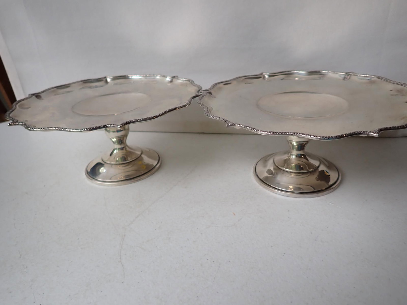 Pair of J.E. Caldwell & Co. Sterling Silver Tazza: Pedestal Dishes. 7 1/2" Diameter. Appr. 3 1/2" High. Marked 8541X. 17.6 troy ounces.