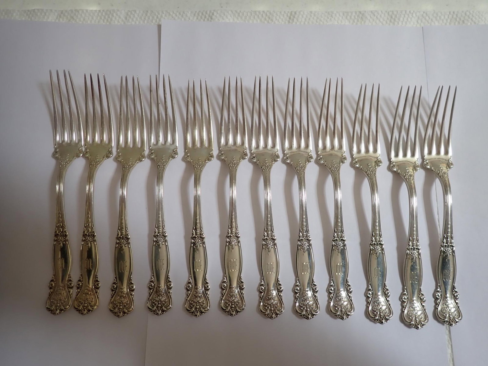 12 Sterling Dinner Forks 7": Monogrammed. 4" x 3 1/4". Total weight. 12.9 troy ounces.