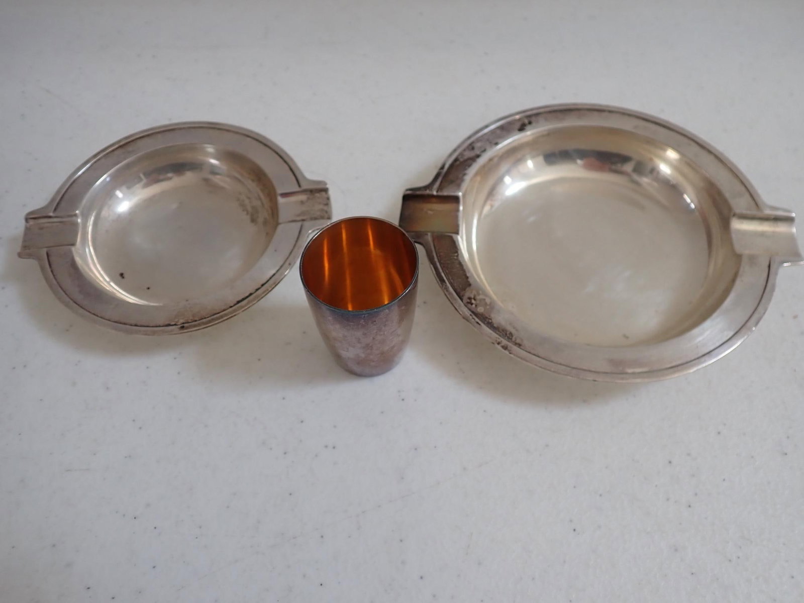 Tiffany & Co. Makers Sterling Silver Ashtrays +: Tiffany & Co. Shot Glass Marked Sterling Germany. Ashtrays measure 4 3/8" 21882 and 3 1/2" 21883. 7.5 troy ounces.