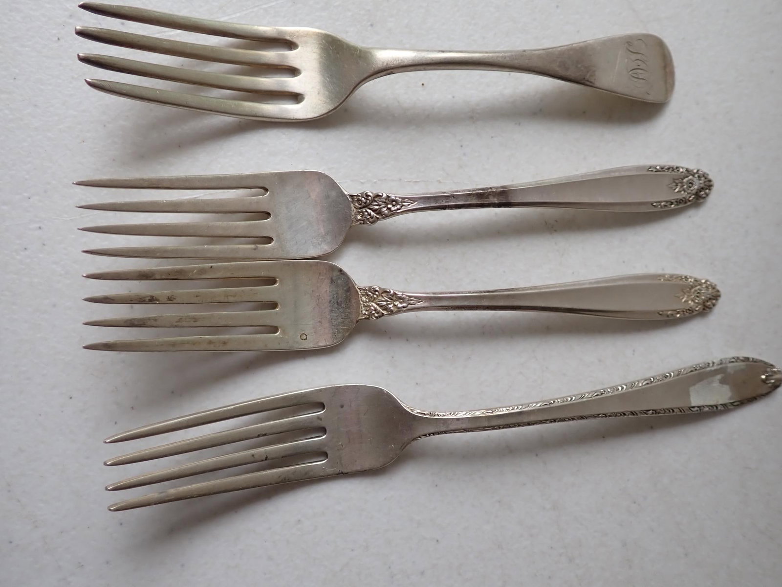 4 Sterling Silver Forks: International Prelude, Alvin Southern Charm, International and other. 6.4 troy ounces.