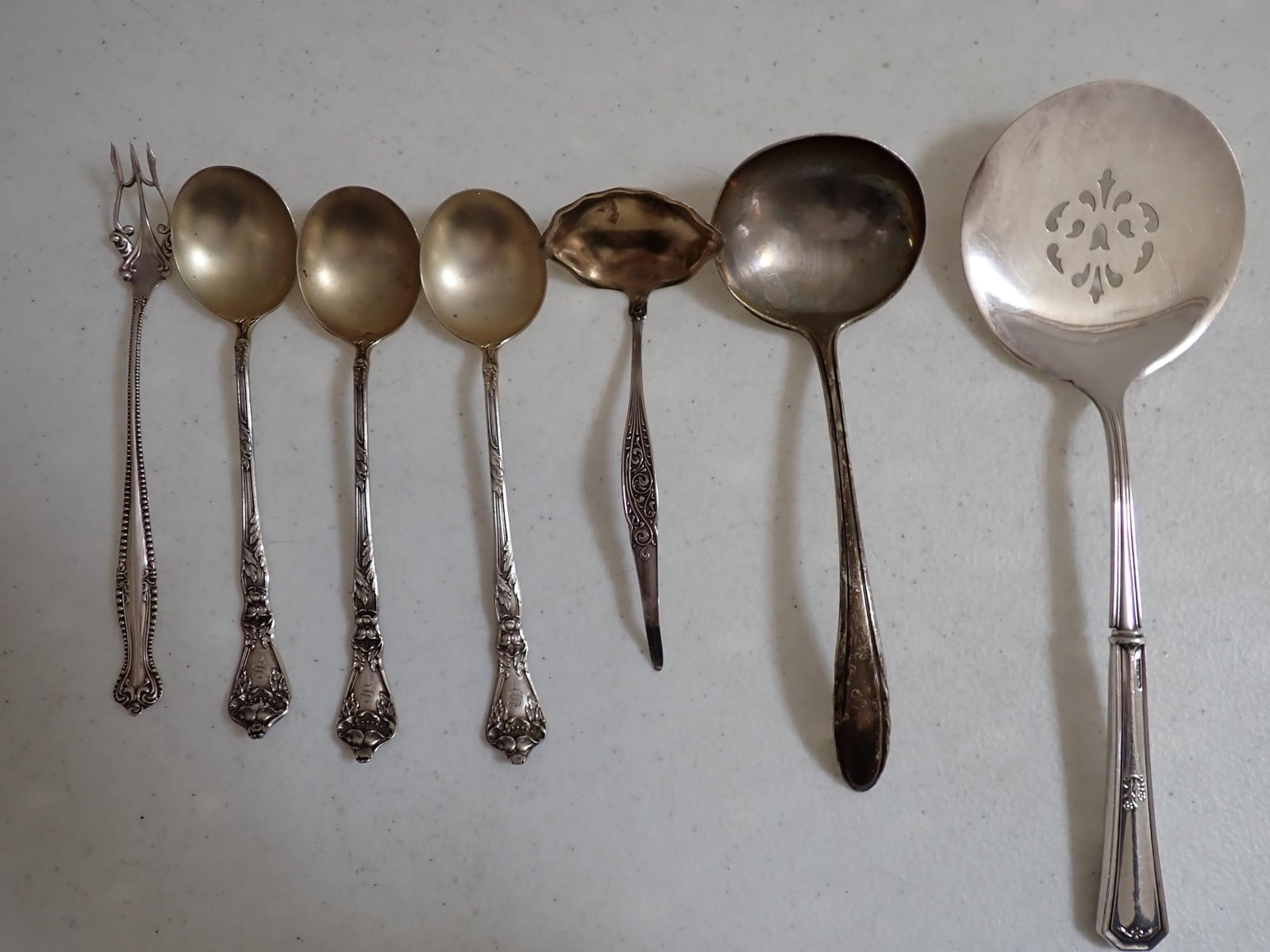 Sterling Silver Serving Spoons and Fork: Marked Pat. Sept 8-14 Slotted Serving Piece with Sterling Handle 9", Gorham Patent 1940 Ladle 7", Henn & Hayes Ladle 5" Sterling Fork 6" and (3) 6" Spoons. 6.2 troy ounces.