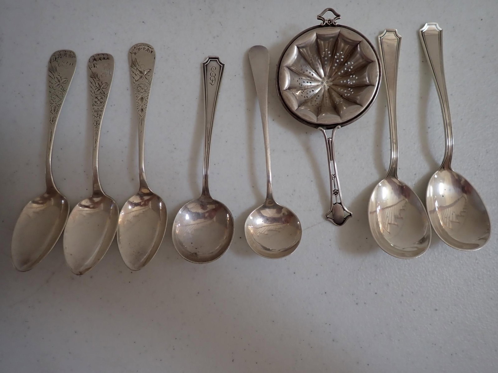 7 Sterling Serving & Other Spoons & Tea Strainer: 5.8 troy ounces.