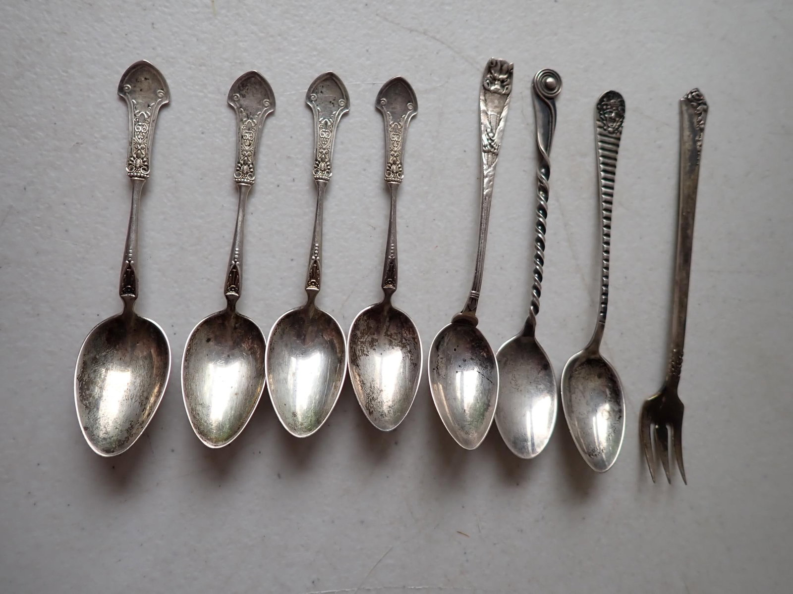 8 Sterling Silver Flatware Pieces: 4 Sterling Demitasse Spoons, Pemark Rose Fork & 3 Other Spoons. 3.0 troy ounces.