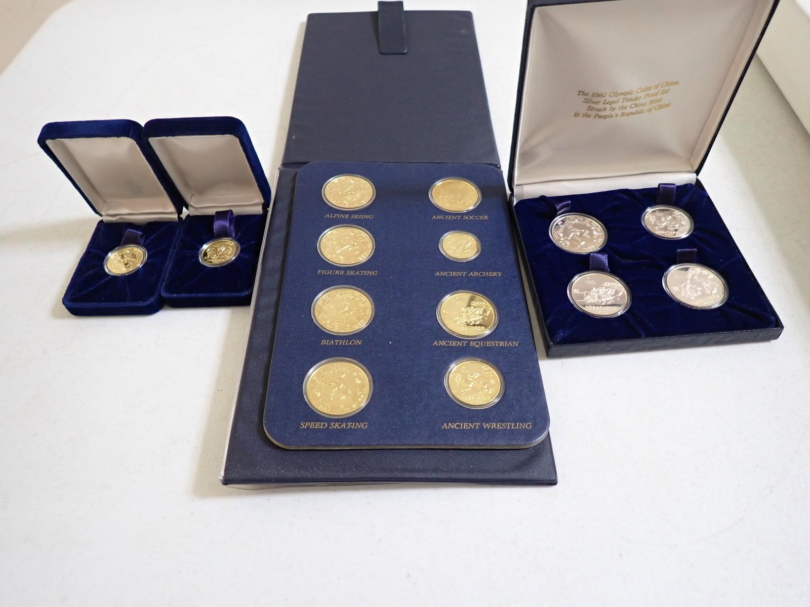 1980 Chinese Gold, Silver, and Copper Olympic Coins: Limited edition Proof Coins. 250 Yuan Gold Alpine Skiing Coin. 300 Yuan Gold Archery Coin. 30 Yuan Silver Speed Skating Coin. 30 Yuan Ancient Equestrian Silver Coin. 30 Yuan Silver Ancient Soccer