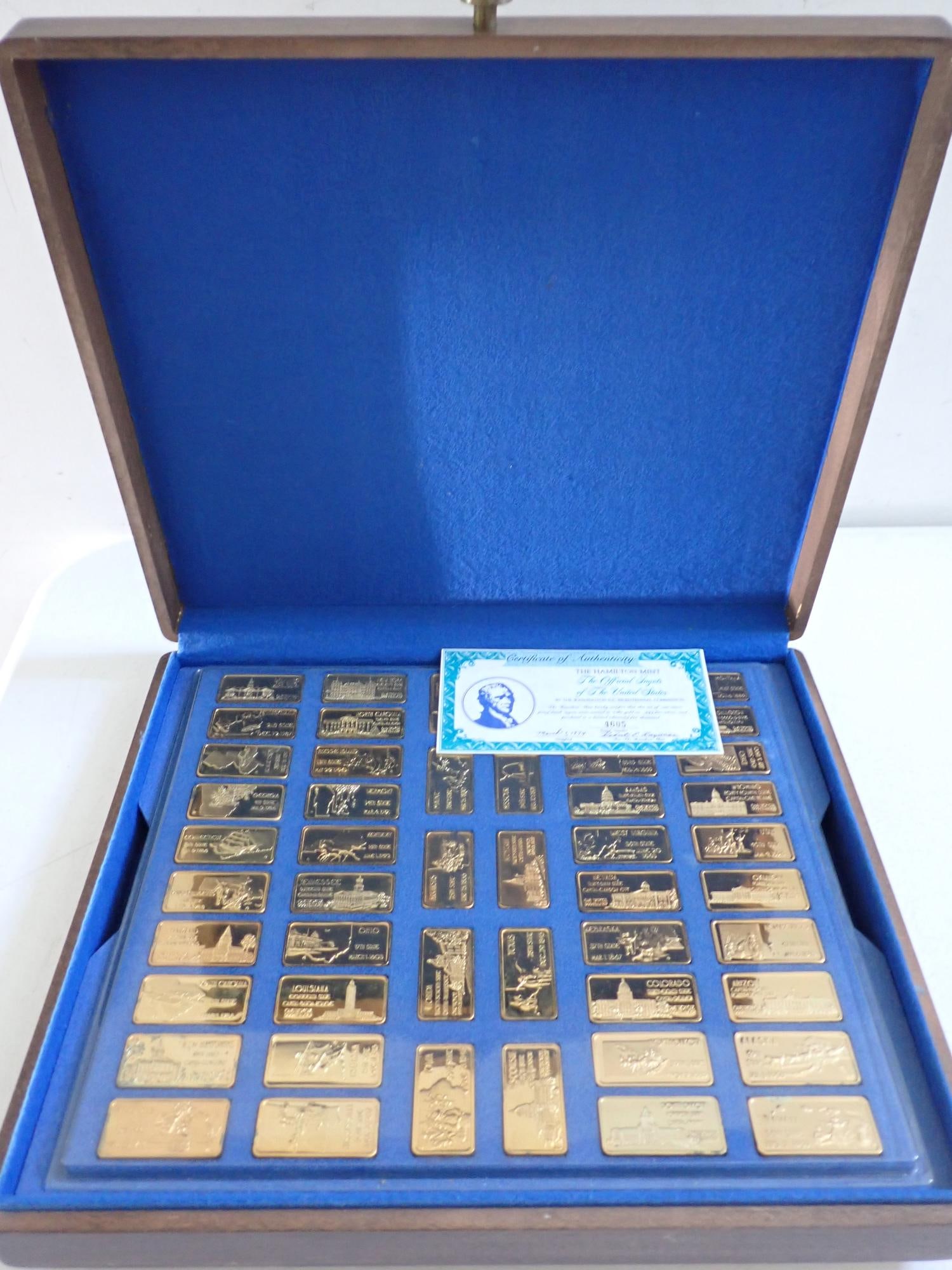 1974 Hamilton Mint Gold Plated Ingots of The United States: Complete set of 50 one ounce ingots. Issued in both a gold-plated and a silver edition. This is the 24 karat gold plated on .999 silver collection. With certificate of authenticity that says " The