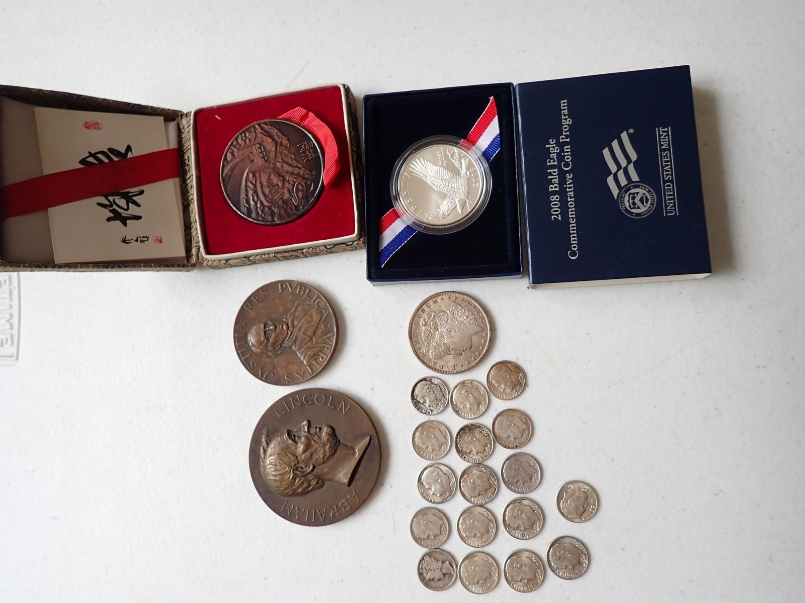 US Silver Coins and Bronze Medals: 1921 Morgan Silver Dollar, 16 Roosevelt & 1 Mercury Dime, 2008 Bald Eagle US Mint Commemorative Coin. Bronze George T. Morgan 100th Anniversary of Lincoln's Birth Medal. Appr. 2 3/8". Bronze St.