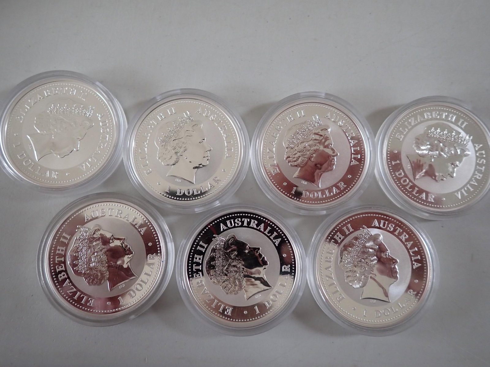 7 One Dollar Australian Silver Coins: (2) 2002 Year of the horse. 2000 Year of the Dragon. 2001 Year of the Snake. 2002 Kookaburra. 2006 Year of the Dog. 1999 Year of the Rabbit.
