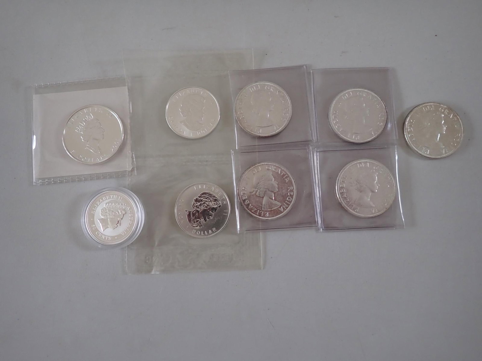 Canadian and Australian Silver coins: 2001 Canadian .999 silver $5 coin. (2) 2006 Canadian .999 Silver 1/2 ounce coins. (5) 1963 Canadian Silver Dollars. 2006 Silver 50 cent 1/2 ounce .999 silver coin.
