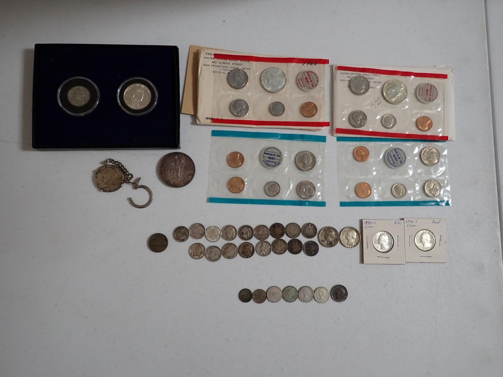 U.S. Silver and other coins: 1968 & 1969 Mint sets with 40% silver halfs. 2005 American Silver Eagle. 1964 Kennedy Half in Worcester Federal Savings Keychain. 1982 Washington Commemorative Half with 1932 Silver Washington Quarter