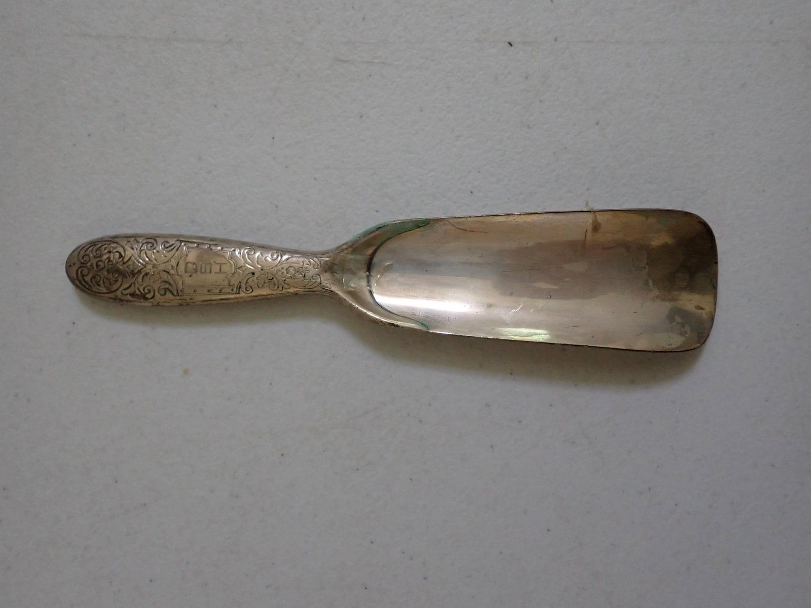 Tiffany ornate sterling shoe horn: Marked Tiffany & Co. Markers and numbered. Scroll design & monogrammed. Some oxidation on edge. 2.5 troy oz.
