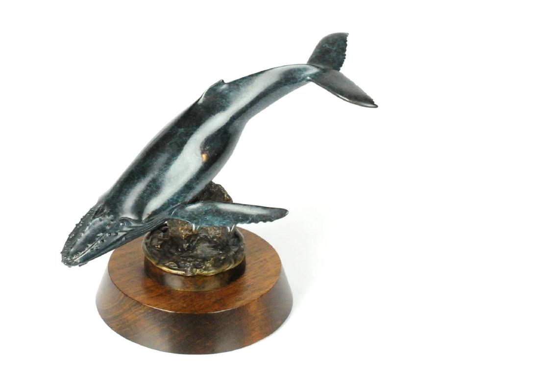 Randy Puckett Bronze Humpback Whale Sculpture: Sculptured teal bronze humpback wale by Randy Puckett. Attached to wood base. Measures: 10" L x 8" H . Signed: Randy Puckett and Numbered: 4/140 2003. Please examine all photos closely. Contact C. Bid