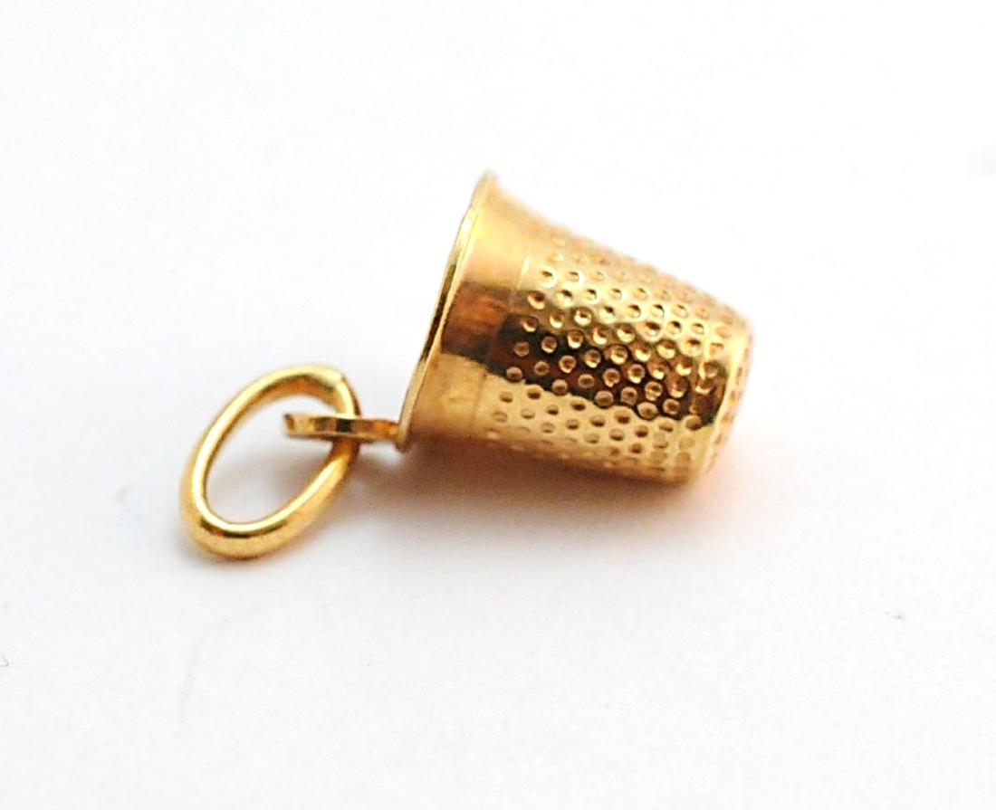 14k Yellow Gold Thimble Charm 585 Italy, 1.3 Grams: 14k Yellow Gold 1.3 grams thimble charm, Marked: 585 Italy. Measures: .75" long including bail. Condition: Excellent. Please examine all photos closely. Contact C. Biddle Auction Gallery for more deta