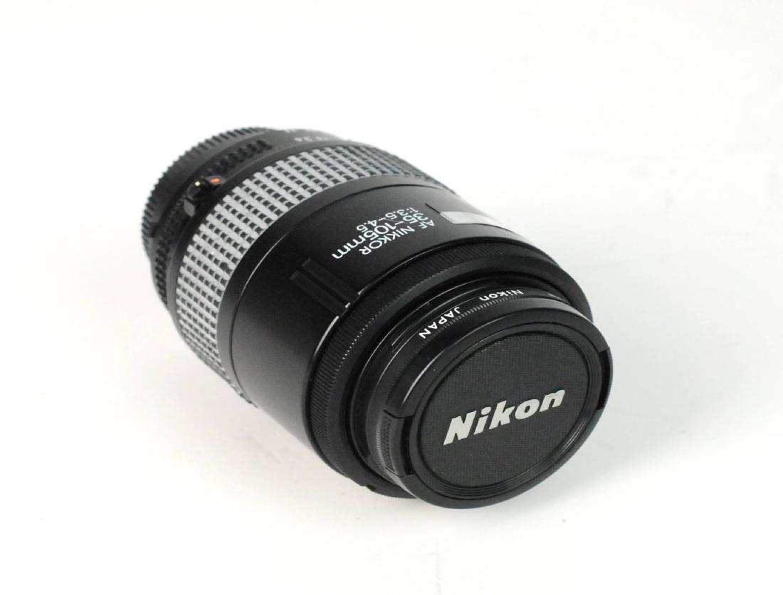 Nikon Nikkor 35-105mm F/3.5-4.5 Autofocus: Nikon Nikkor 35-105mm F/3.5-4.5 Macro Early (with Focus Scale Window) Autofocus Lens. With lens caps. Sold As Is. Please examine all photos closely. Contact C. Biddle Auction Gallery for more detailed
