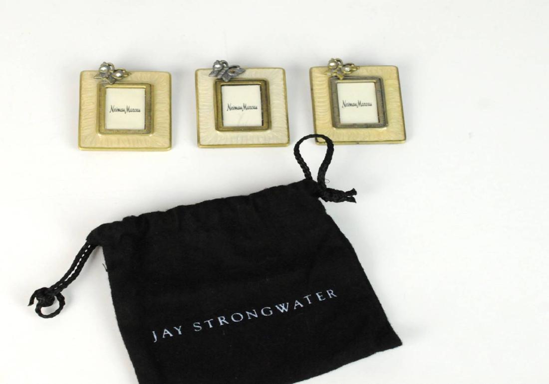 3 Jay Strongwater Mini Butterfliy Picture Frames: 3 Jay Strongwater mini picture frames with beige and white enamel adorned with a crystal and accented with butterfly. Signed: Jay Strongwater. Measures: 2"H x 1/5"W. Condition: The white frame is miss