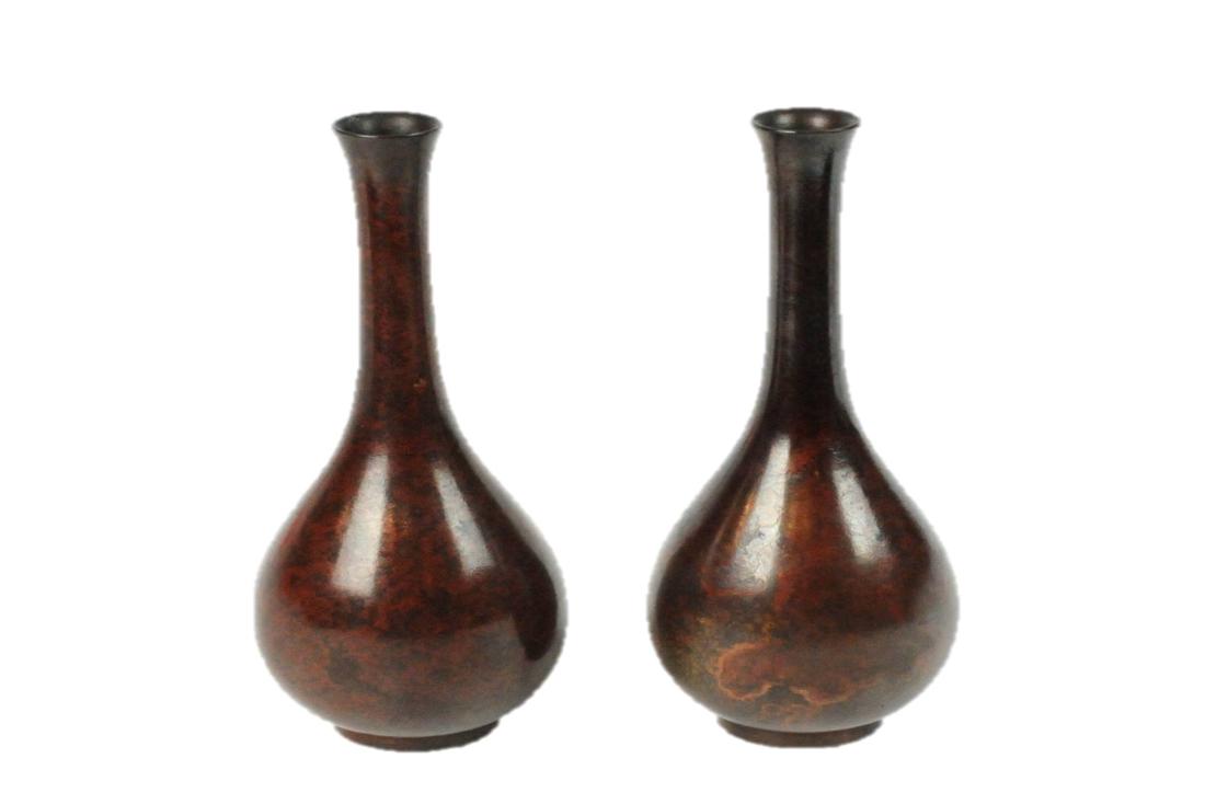 Pair Bronze Mottled Japansese Meiji Bud Vases: Pair of Bronze Mottled Japanese Meiji Bud Vases. Measures: 3.5 " D x 8.5" H Condition: Very Good. Please examine all photos closely. Contact C. Biddle Auction Gallery for more detailed information. C.