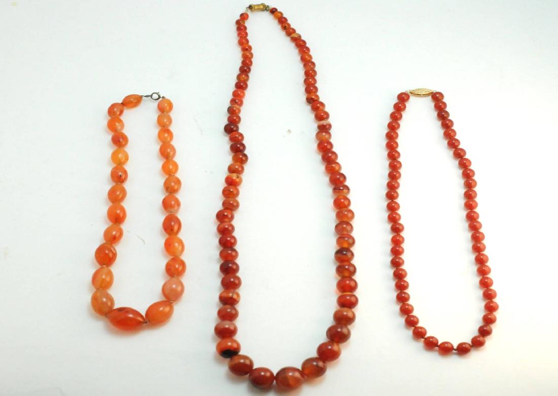 3 Carnelian Bead Strand Necklaces 14k Clasp: 3 carnelian bead necklaces. Size: A: 26" L with graduating beads from 6-15mm. B: 18" L with 8mm beads and clasp marked 14k. C: 16"L with graduating oval beads from 8-15mm. Condition: Very Good. Please