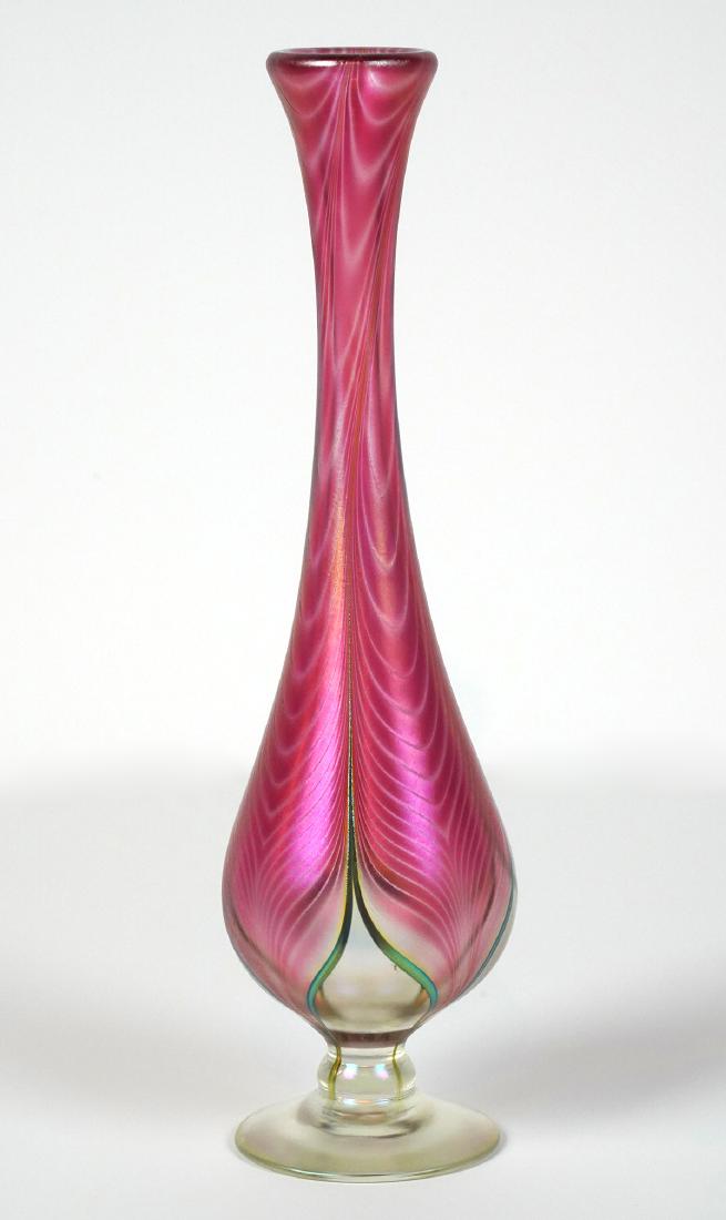 Stuart Ableman Irredescent Feathered Vase: Stuart Ableman Irredescent feathered pulled vase in pink / purple. 13"H. Condition: Very Good. Please examine all photos closely. Contact C. Biddle Auction Gallery for more detailed information. C. Bi