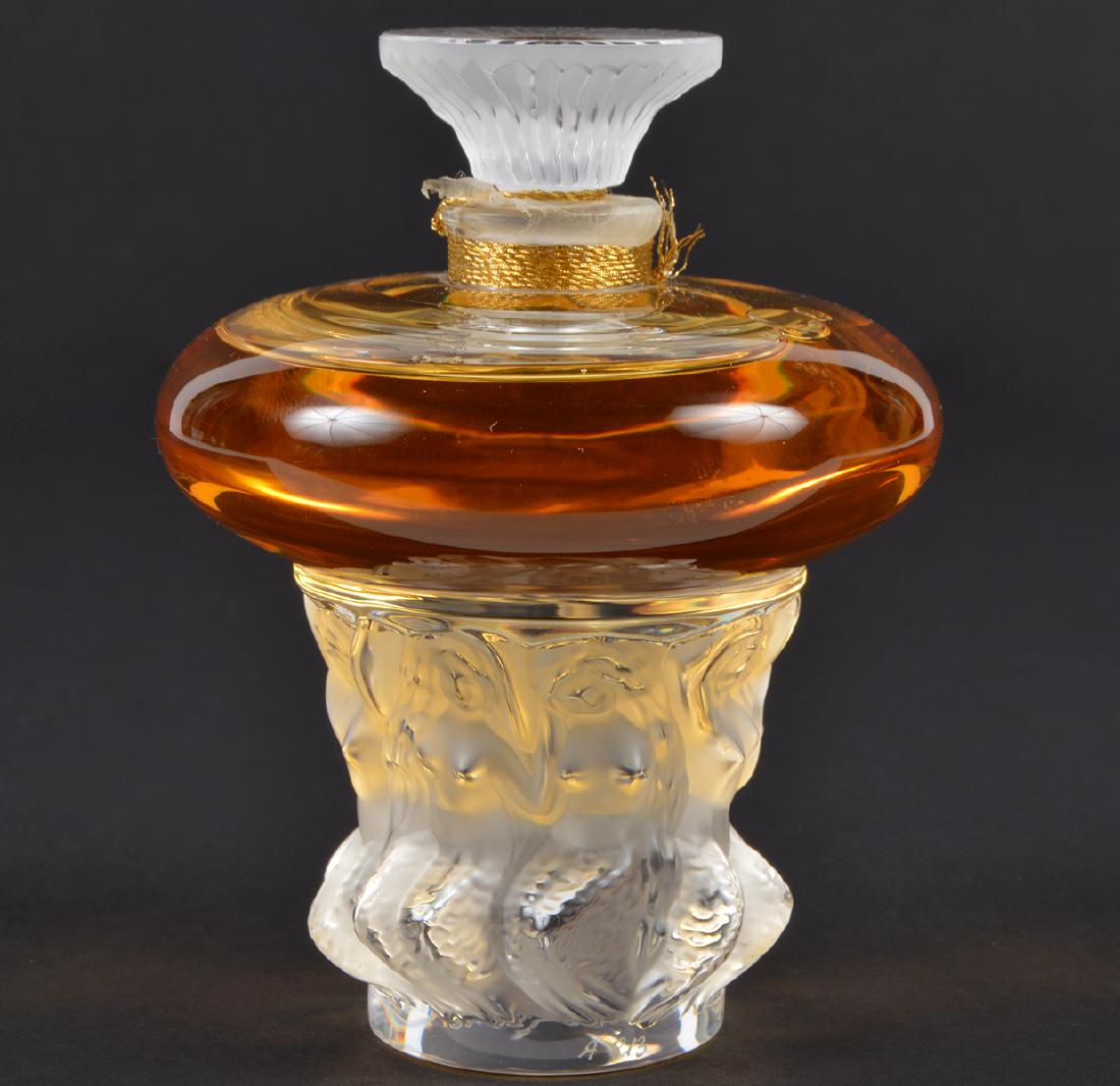 Les Sirenes Lalique Parfum Sealed Signed: Lalique Les SirÃ¨nes in crystal bottle with nudes on the base. Signed. Sealed. 2.7oz. 4.5"H x 3.5"W. Condition: Very Good. Please examine all photos closely. Contact C. Biddle Auction Gallery for mo
