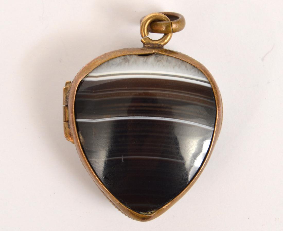 Victorian Banded Agate & Bloodstone Heart Locket: Victorian heart shaped locket with a banded agate on one side on a bloodstone on the other side. 1.25"Lx.75"W. Condition: Very good light tarnish on metal. Please examine all photos closely. Contact C