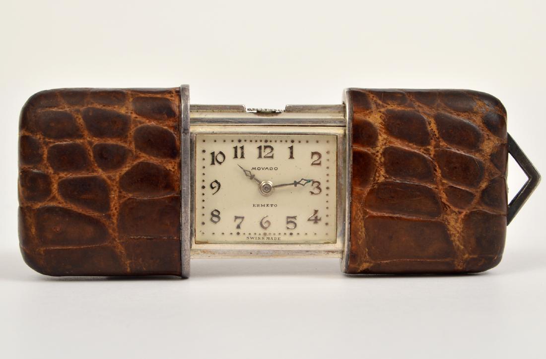 Art Deco Movado Ermeto Travel Watch Croc Case: Movado Ermeto Art Deco travel watch. This unique piece winds as you open and close it. In a croc case. 1.75"L when closed, 2.5"L when opened. Please examine all photos closely. Contact C. Biddle Aucti