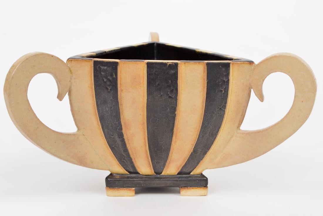 G. D. Pasquale Pottery Striped Brown Beige Vase: Unique pottery signed by the artist, G. D. Pasquale, on the bottom. In a triangular shape with 3 curved handles. The vase is brown and beige striped.9"D x 4.5"H. Condition Report: Very good - no issue