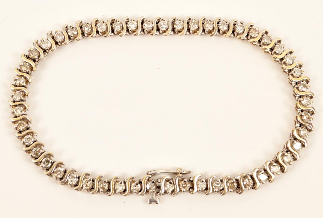 Ladies Diamond 14k White Gold Tennis Bracelet: Ladies diamond tennis bracelet containing approximately 2.5 carats of brilliant cut diamonds I color, SI clarity in a prong S curve setting. 7.5"Lx4.7W. Weight 12.2 grams. Condition report: very good 
