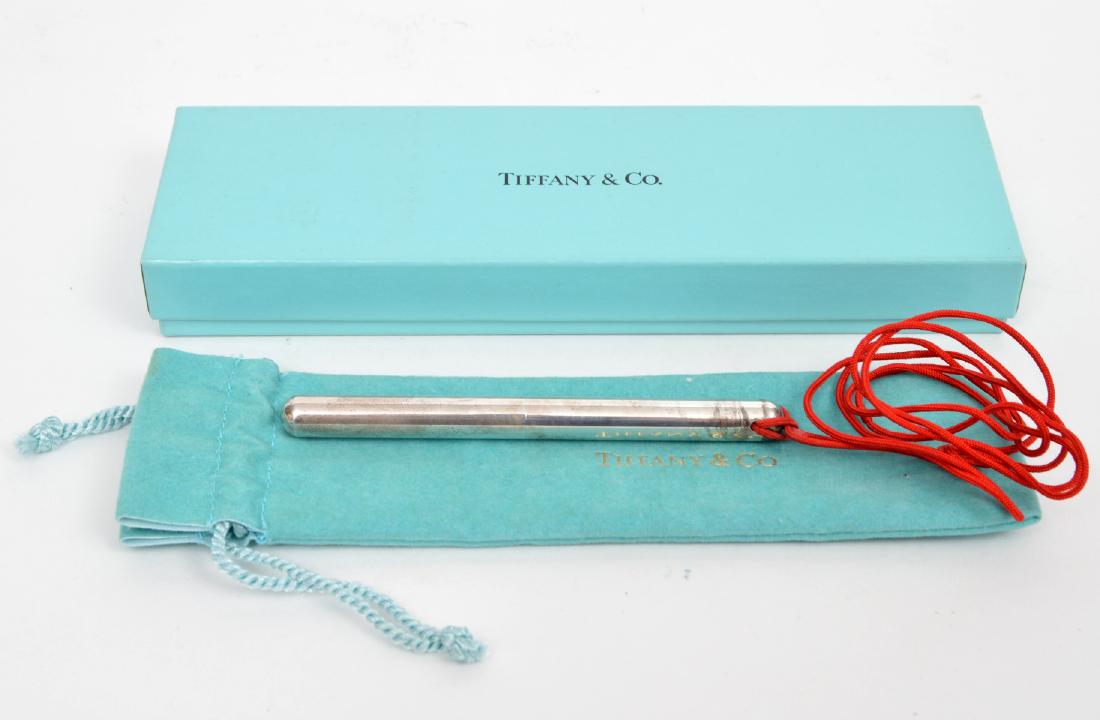 Tiffany & Co Elsa Peretti Sterling Silver Pen: Tiffany & Co Elsa Peretti sterling silver ballpoint pen on red neck cord. 14.4 grams. 4" long, in Tiffany Pouch and box. Marked: Tiffany & Co Perettie 925. Condition report: Very good - no issues. Ple