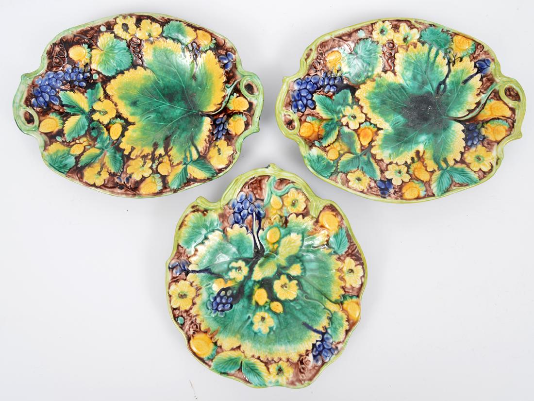 3 Majolica Serving Bowls Green Leaf Pattern: 3 Mojolica earthenware serving bowls, in a yellow flower and green leaf pattern. Two are oblong - 11"Lx8.25"W and one is in the shape of a leaf - 9.5"Lx8.5"W. Condition report: Very good with some scr