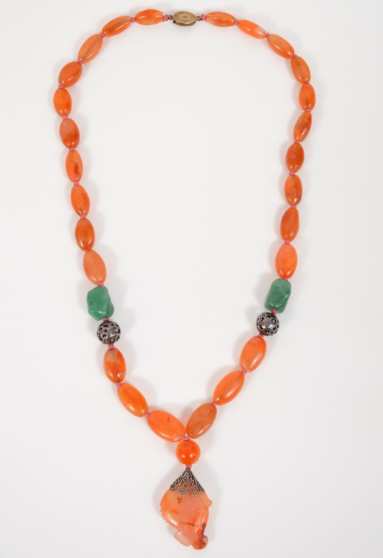 Cornaelian Aventurine Silver Necklace Fish Pendant: 24" strand necklace of Carnelian accented with aventurine and silver pierced baubles. Each bead is individually knoted. The pendant is a hand carved fish. Secure silver clasp. Condition report: Very g