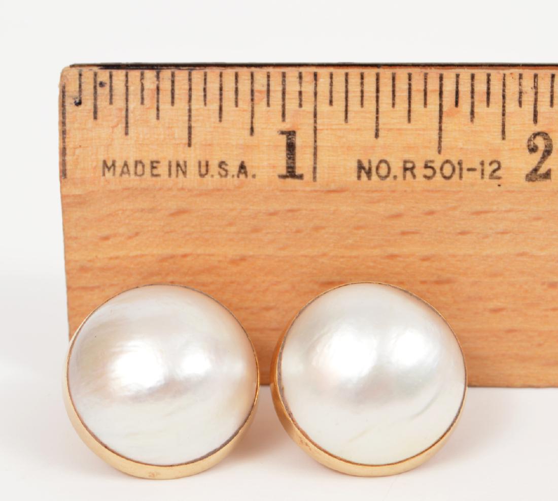 19mm Mabe Pearl Pierced Earrings 14k Yellow Gold: 19mm mabe pearl post earrings, set in a 14k yellow gold bezel, with omega backs. Weight: 14.5 grams. Condition report: Very good - no issues. Please examine all photos closely. Contact C. Biddle Aucti