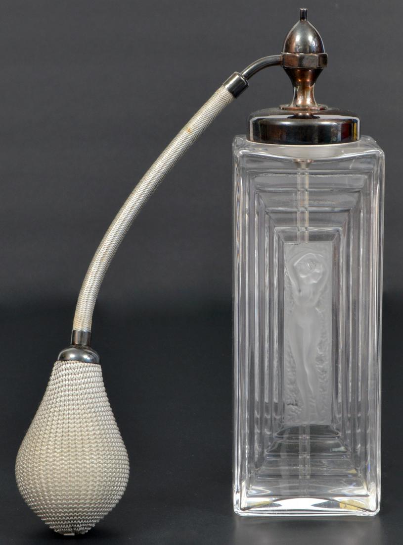 Lalique Perfume Bottle with Duncan Atomizer: Vintage Lalique perfume bottle features a frosted nude center and Duncan atomizer. 8"H. Condition report: Very good - no issues. Please examine all photos closely. Contact C. Biddle Auction Gallery fo