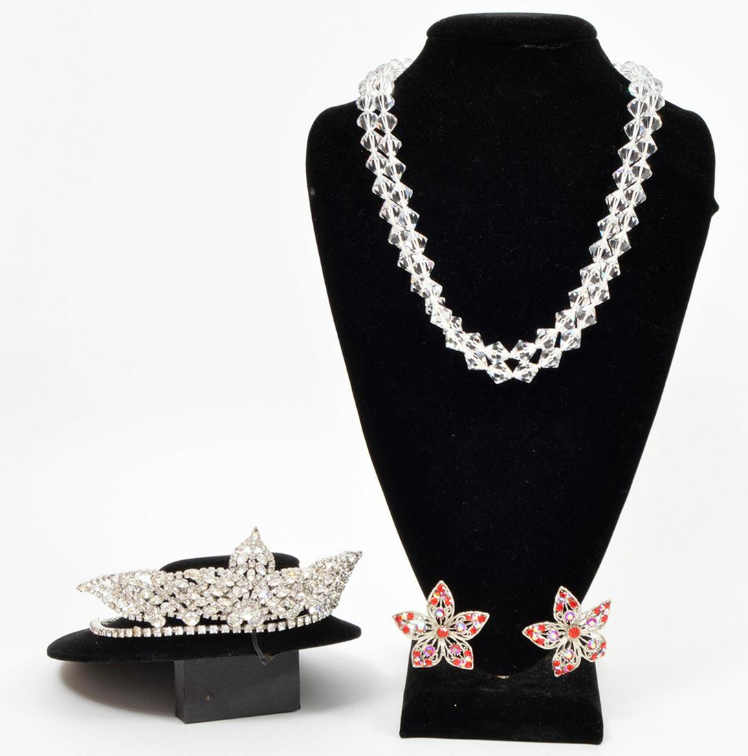 Crystal Tiara Crown, Necklace & Earrings: Crystal and silver tone tiara crown (2.5"H at top x 5 1/8"W with 4.25"L chains), lead crystal necklace (46"L) and red crystal flower clip on earrings (2" x 2"). Condition report: good overall conditio