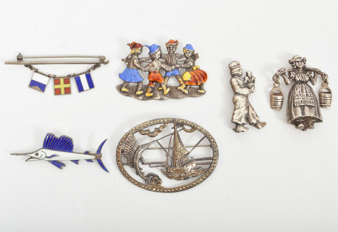 6 Sterling Silver Enamel Brooches: 6 sterling silver brooches including a dutch milk maid, a bar pin with three enamel nautical flags, an enamel swordfish, a framed marcasite ship and swordfish, a dutch boy carrying a tulip and an enam