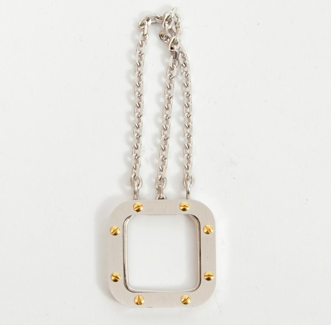 Must de Cartier Silver & Gold Tone Scarf Clip: Must de Cartier Silver tone and gold tone scarf clip with dangling chains. Made in France. 1.1" x 1.1". Signed. Condition report: Very good - no issues. Please examine all photos closely. Contact C. B