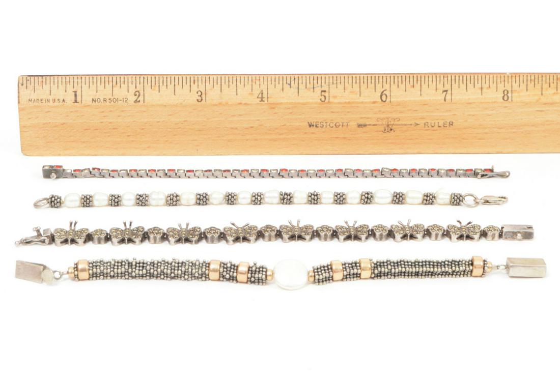 4 Sterling Bracelets Marcasite Pearl Crystals: 4 sterling silver bracelets: a freshwater pearl bracelet, a marcasite butterfly bracelet, a fresh water disc pearl and silver bead bracelet, and a red and clear crystal bracelet. 6.75"L to 7"L. Condit