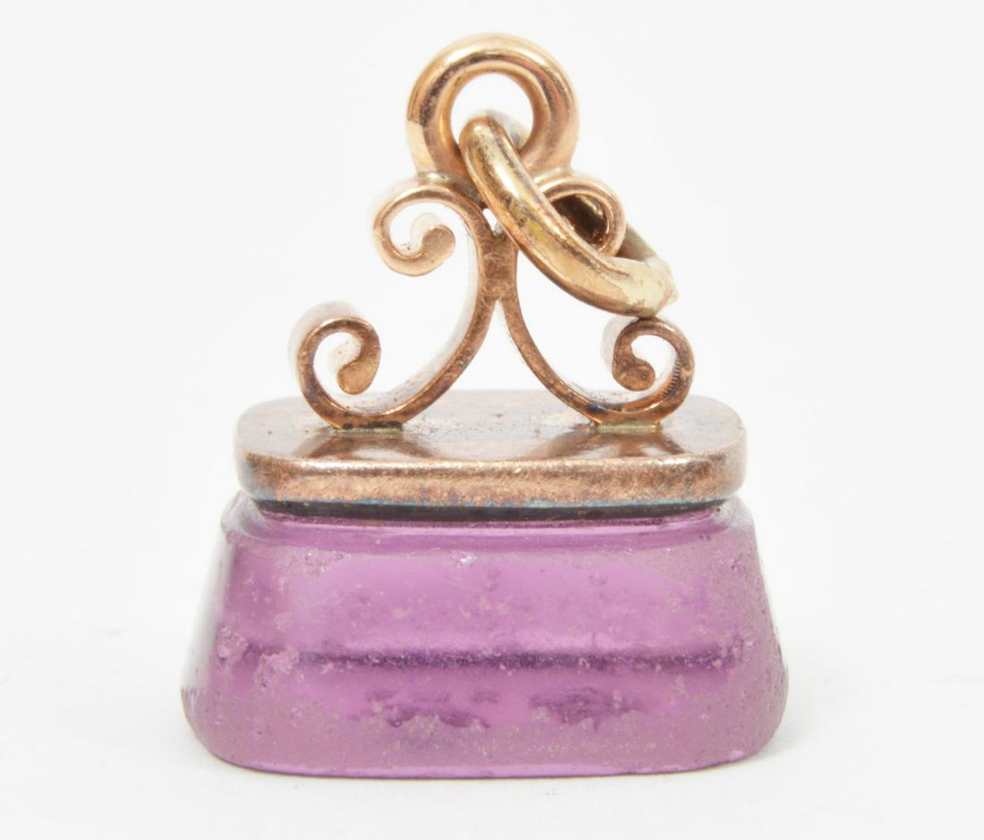 Victorian 14k Gold Fob Amethyst Intaglio: Victorian 14k yellow gold fob with large amethyst intaglio. 7/8"L. Total weight: 7.1 grams. Condition report: amethyst is heavily scratched around the edges. Please examine all photos closely. Contact
