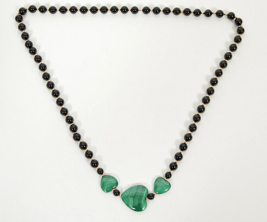 Onyx & Malichite Strand Necklace 14k YG: A 28" strand of 9mm black onyx beads interspersed with 2.5mm 14k yellow gold beads and accented with 3 malachite hearts. Condition report: Very good - no issues. Please examine all photos closely. Con