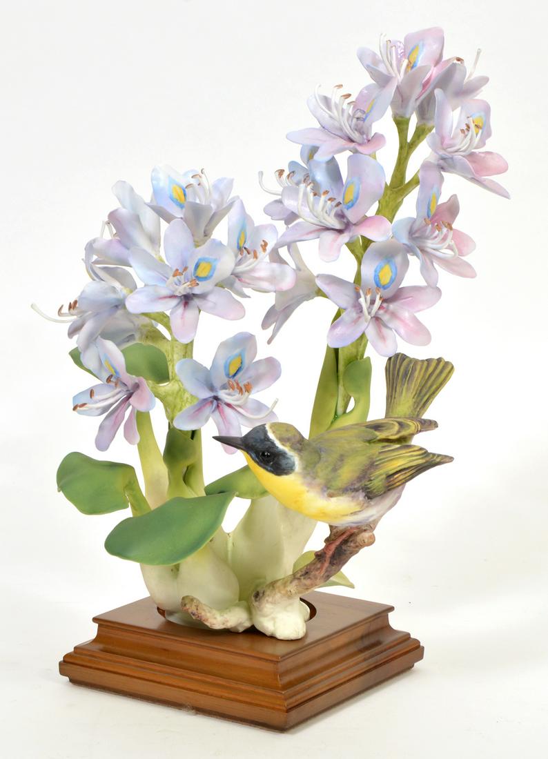 Royal Worcester Yellowthroat on Water Hyacinth: Royal Worcester yellow throat Geothlypis Trichas perched on lavender water hyacinth. Signed and numbered on bottom, #4001 and sits in fitted wood base. Designed by Dorothy Doughty for the 'American Bi
