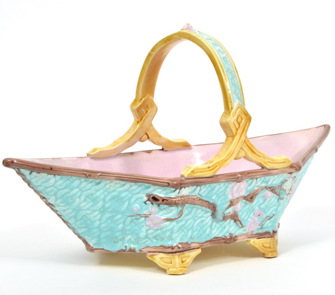 Vintage Majolica Glazed Earthenware Basket: Majolica vintage basket in pastel colors with single handle, raised on 4 feet. Diamond shaped body measures 15.25"L x 6.75"W x 8.5"H. Condition report: good condition, hairline 2" crack on inside, see
