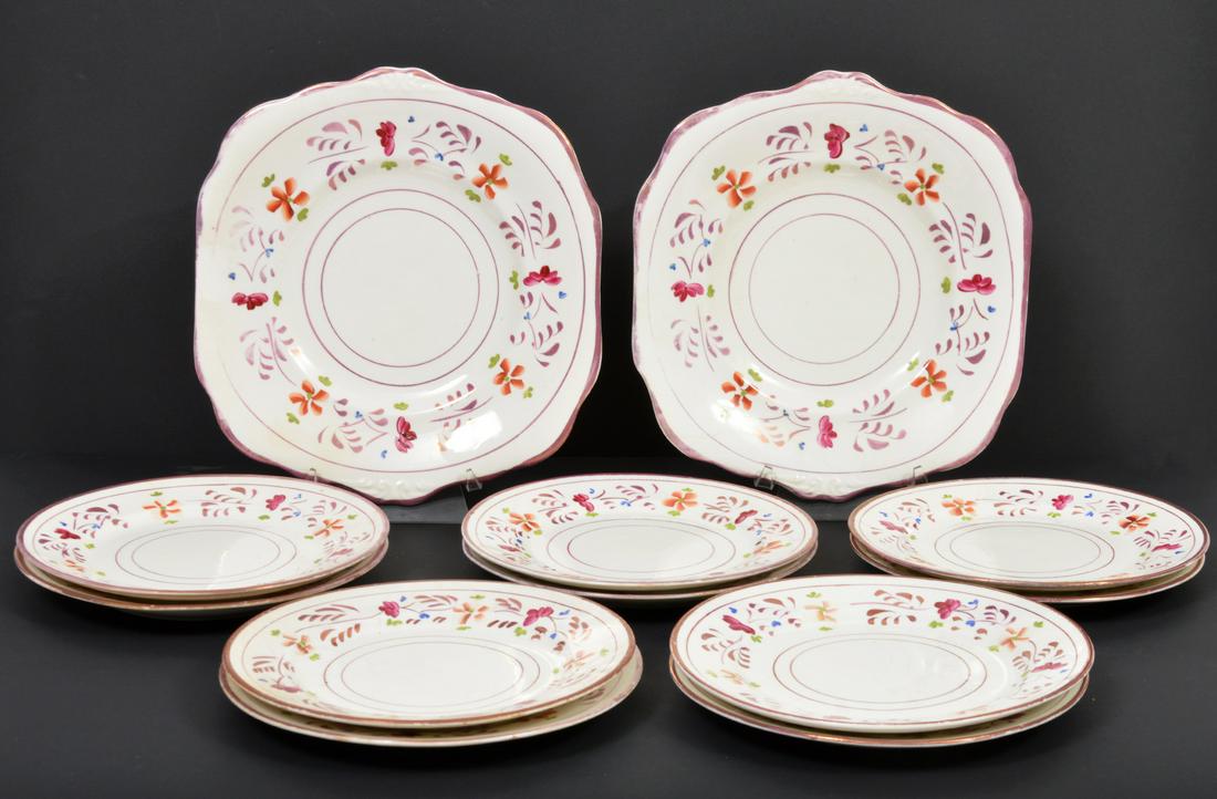 31 Pcs. English Lusterware: 31 pieces of English lusterware with a floral motif and accented with gilt. This group includes 1 creamer raised on pedestal base (4.75"H x 5"L x 4"W); 9 tea cups (2.5"H x 4.25"W); 9 saucers (5.5"W);