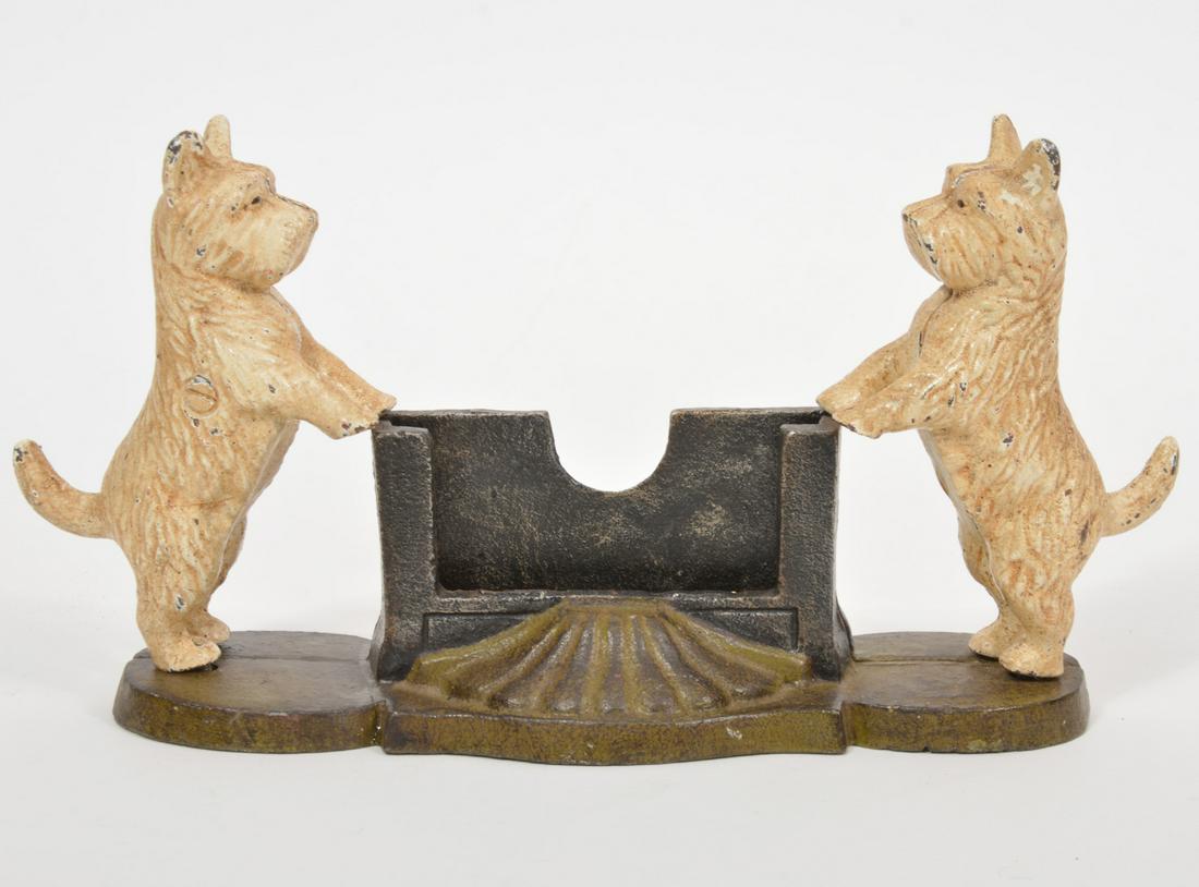 Vintage Scottie Dog Cast Iron Business Card Holder: Vintage Scottie Dog Cast Iron business card holder with decorative shell design on front and back. Measures 11.5"L x 6"H x 3"W. Condition report: one dog is loose, wear commensurate with age, see phot