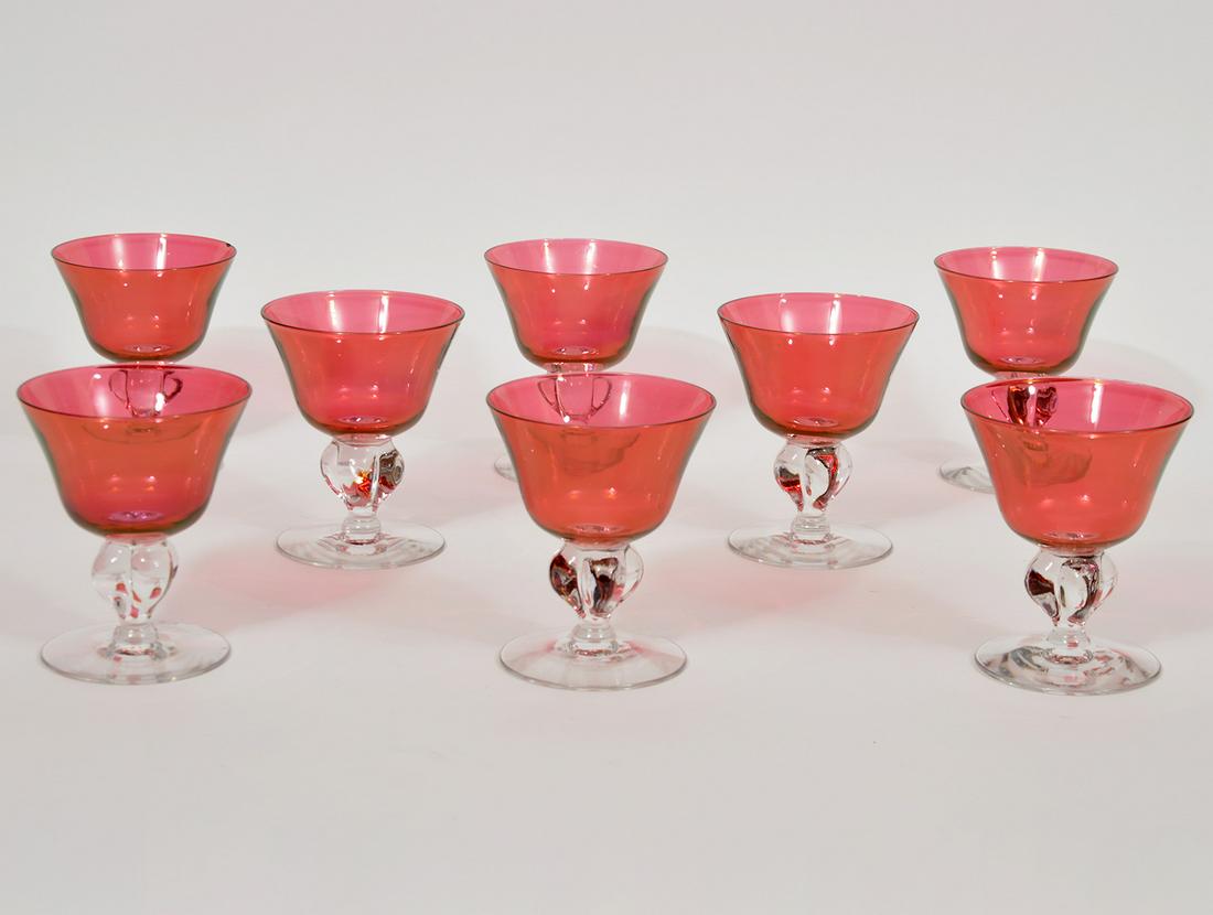 8 Cranberry Wine Glasses With Clear Stems: 8 Cranberry wine glasses with clear stems. 5.5"H x 3.5"D. Condition report: Good, one has a small chip. Please examine all photos closely. Contact C. Biddle Auction Gallery for more detailed informati