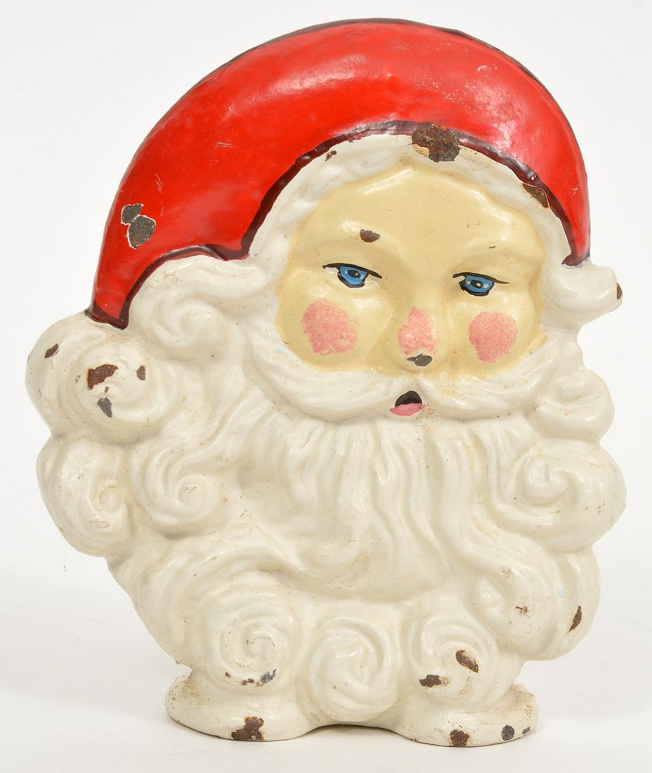 Santa Claus Iron Painted Doorstop: Santa Claus iron painted doorstop. 7.5"H. Condition report: several spots have missing paint. Please examine all photos closely. Contact C. Biddle Auction Gallery for more detailed information. C. Bid